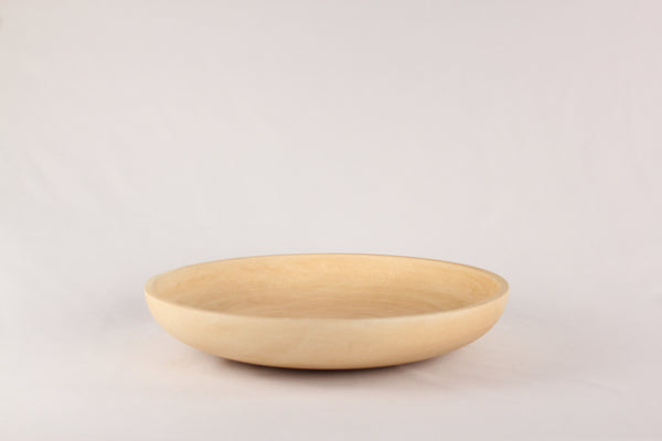 Mango wood plate on a white surface