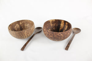 Two coconut bowls with two sugar palm wood spoons